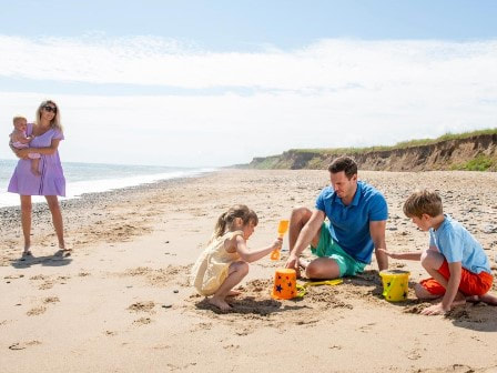 Family building sandcastles at Barmston Beach Holiday Park in Yorkshire