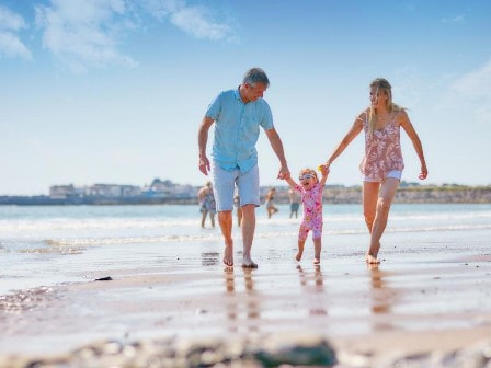 Family on beach at Trecco Bay Holiday Park