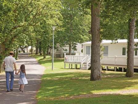 Family walking amongst caravans at Hoburne Bashley