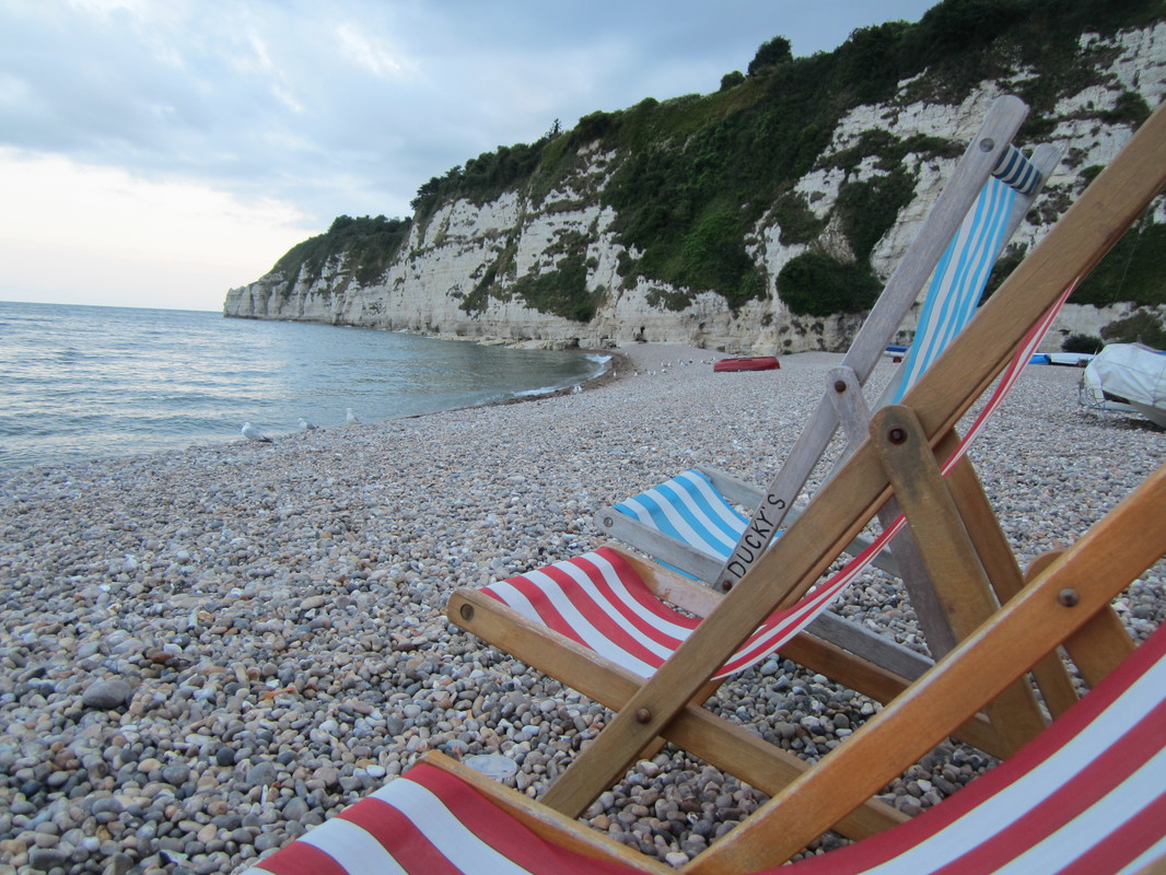 Deckchairs on a shingly beach in Devon