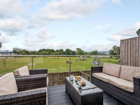 Lodge with balcony overlooking Loch Carlingwark in Scotland