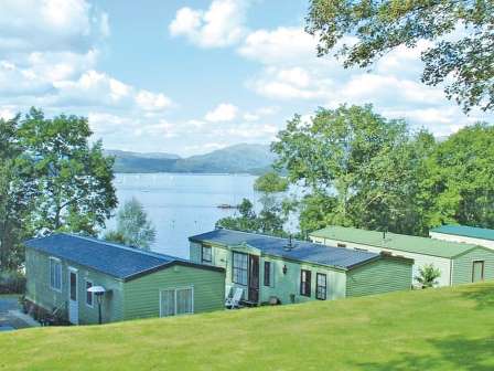 Caravans overlooking lake at Fallbarrow Holiday Park