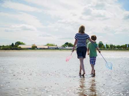 Family walking on the beach at Seton Sands Holiday Park