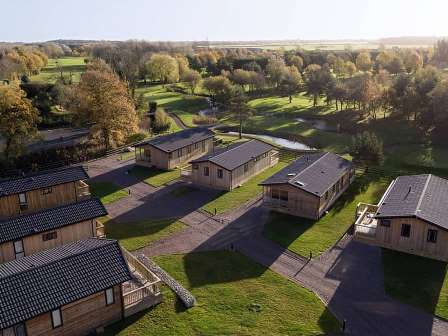 Lodges near woodland at the manor resort