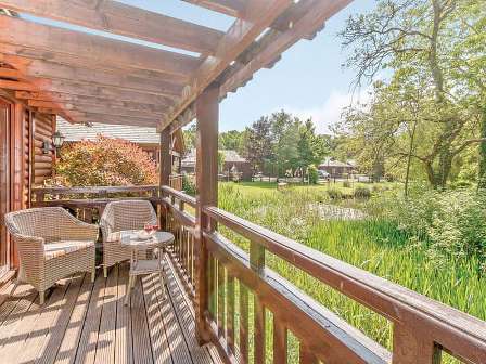 Chairs on balcony at Tilford Woods Lodge Retreat