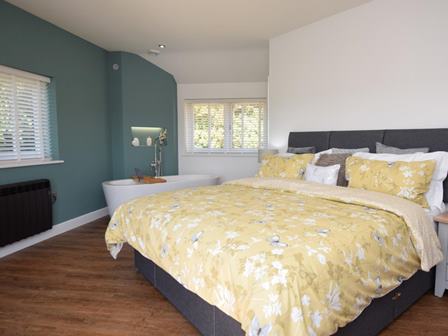 Bedroom at dog friendly Honey Bee Cottage in Dorset with hot tub